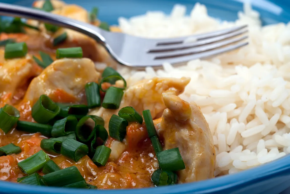 Studio,shot,of,peanut,butter,chicken,and,rice,meal,on