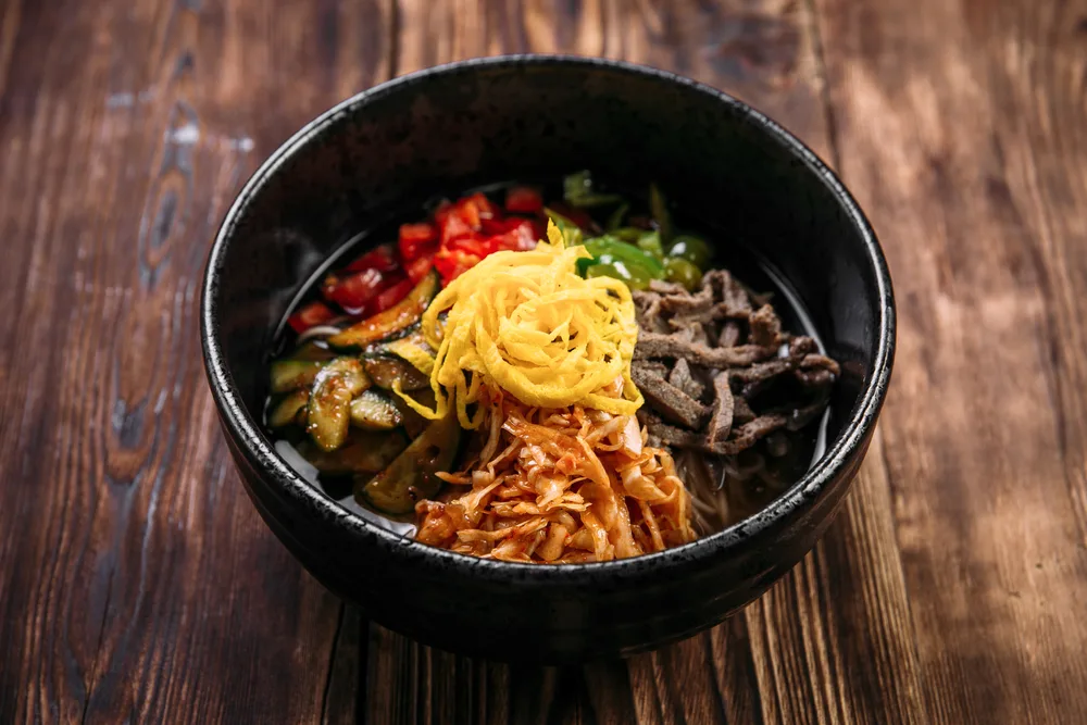 Side,view,on,korean,cold,soup,kuksi,with,vegetables,and