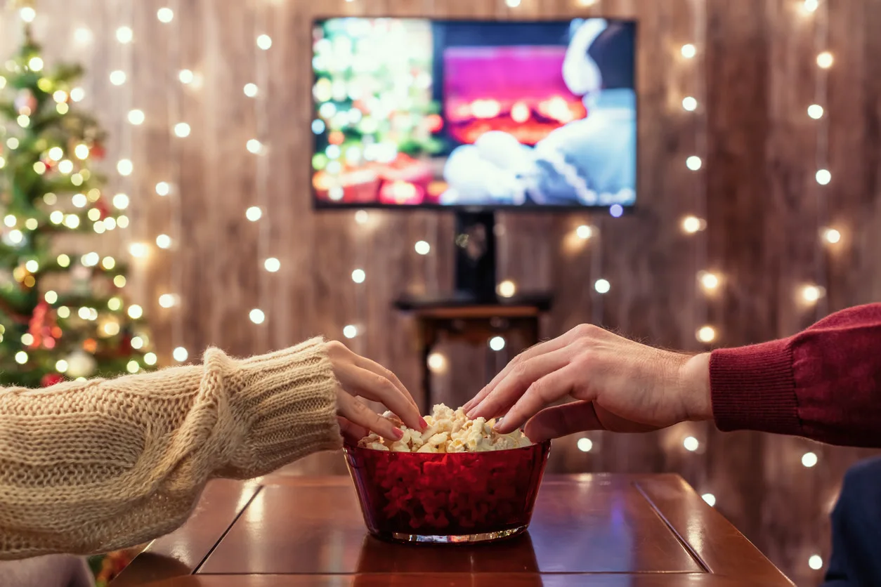 Christmas Eve. Couple Watching Tv And Eating Popcorn. Home Cinema. Cropped, Close Up